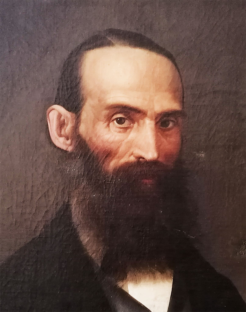 Dipinto ad olio su tela del 1800: gentiluomo con sguardo austero, occhi penetranti, barba incolta, giacca e panciotto eleganti, raffigurato di tre quarti, dettaglio